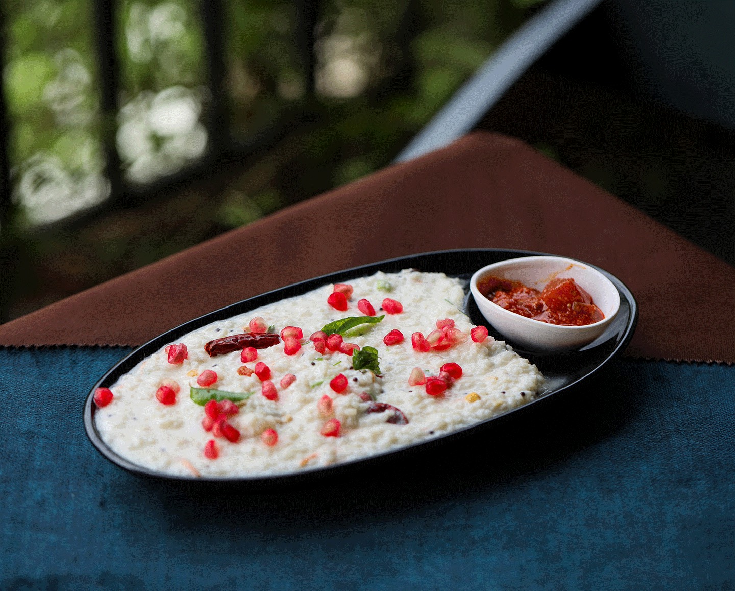 Curd rice garnished with pomegranate